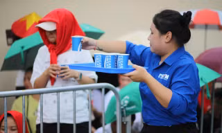 Tình nguyện viên tiếp sức người dân xem sơ duyệt diễu binh, diễu hành