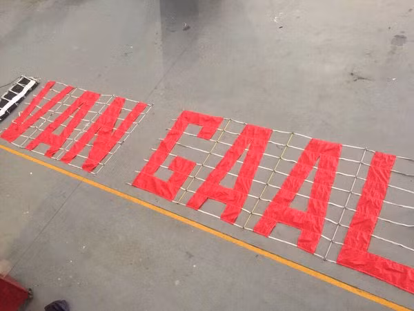 CĐV M.U chuẩn bị biểu ngữ yêu cầu sa thải Van Gaal. 