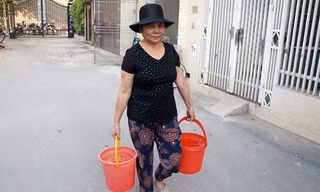 Bà Mơ đi xin nước về dùng tạm. Ảnh: Tuấn Minh