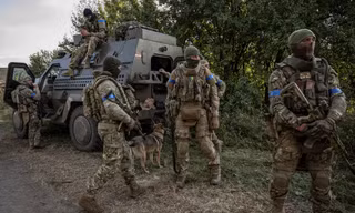 Lính Ukraine đứng gần chiếc xe quân sự ở khu vực gần biên giới Nga ngày 16/8. (Ảnh: Reuters)
