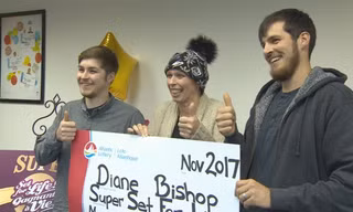 Diane Bishop (giữa) cùng hai con trai vui mừng nhận thưởng tại công ty xổ số. Ảnh: CBC