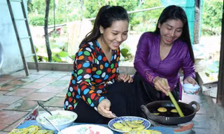 Nghệ nhân Lê Thị Bé Bảy (phải) hướng dẫn khách làm bánh. Ảnh: K. Mai.