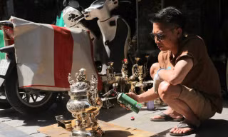 Ông Sơn đang sơn bóng đồ đồng