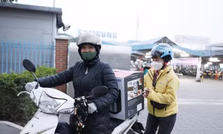 Chị Nguyễn Thị Mười phấn khởi có “cuốc” xe ôm chở một nữ công nhân sau giờ tan ca làm việc ảnh: Nguyễn thắng