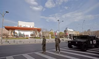 Binh sĩ đeo khẩu trang đứng gác trên đường phố thủ đô Bucharest của Romania ngày 28/3. Ảnh: Xinhua.