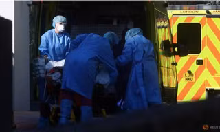 Nhân viên y tế vận chuyển bệnh nhân bên ngoài bệnh viện St. Thomas ở London hôm 26/3. (Ảnh: Reuters)