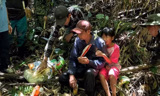Ông Nguyễn Hữu Hà (đội mũ đỏ) được tiếp nước cùng đồ ăn.