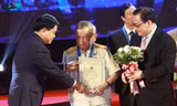 Bí thư Thành ủy Hoàng Trung Hải và Chủ tịch UBND TP Nguyễn Đức Chung trao danh hiệu công dân Thủ đô ưu tú cho anh hùng La Văn Cầu. Ảnh: Vietnamnet