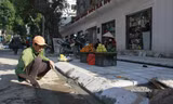 Công nhân thực hiện lát đá vỉa hè trên địa bàn quận Hai Bà Trưng Ảnh: Trường Phong 