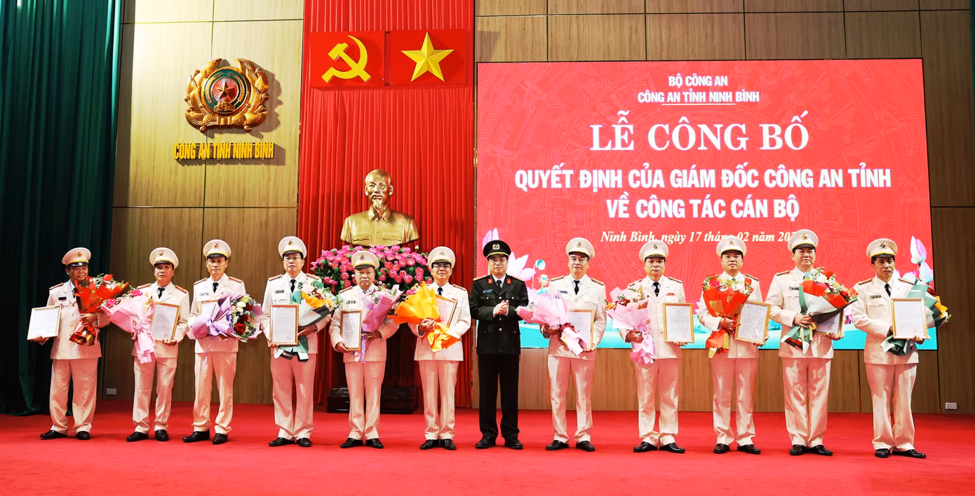 Đại tá Đinh Việt Dũng, Giám đốc Công an tỉnh trao quyết định và tặng hoa chúc mừng các đồng chí nghỉ công tác, hưởng chế độ hưu trí và nghỉ công tác chờ hưởng chế độ hưu trí trước hạn tuổi.