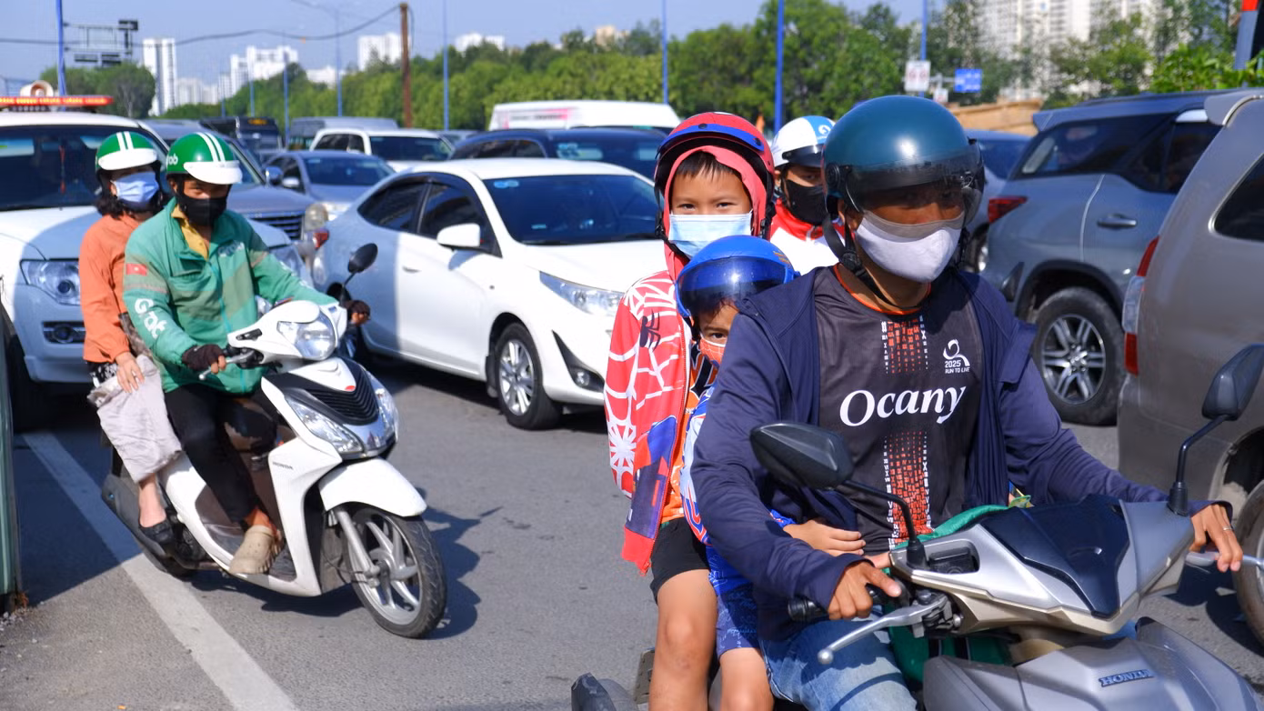 Thời tiết nắng nóng gay gắt, người dân "mướt mồ hôi" di chuyển qua khu vực nút giao giữa đường Mai Chí Thọ với đường Đồng Văn Cống.