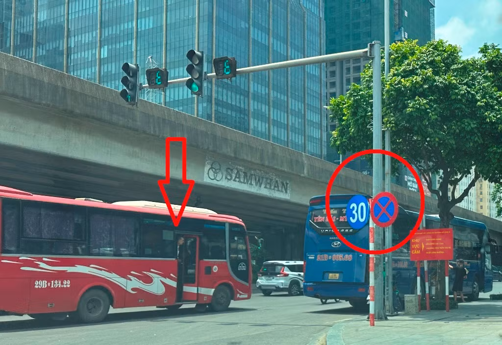 Xe khách kéo dài diễu phố trên đường Phạm Hùng, phụ xe mở cửa thò đầu ra ngoài vẫy khách, bên cạnh là biển cấm dừng đỗ và cấm đi chậm dưới 30 km/h Xe khách kéo dài diễu phố trên đường Phạm Hùng, phụ xe mở cửa thò đầu ra ngoài vẫy khách, bên cạnh là biển cấm dừng đỗ và cấm đi chậm dưới 30 km/h