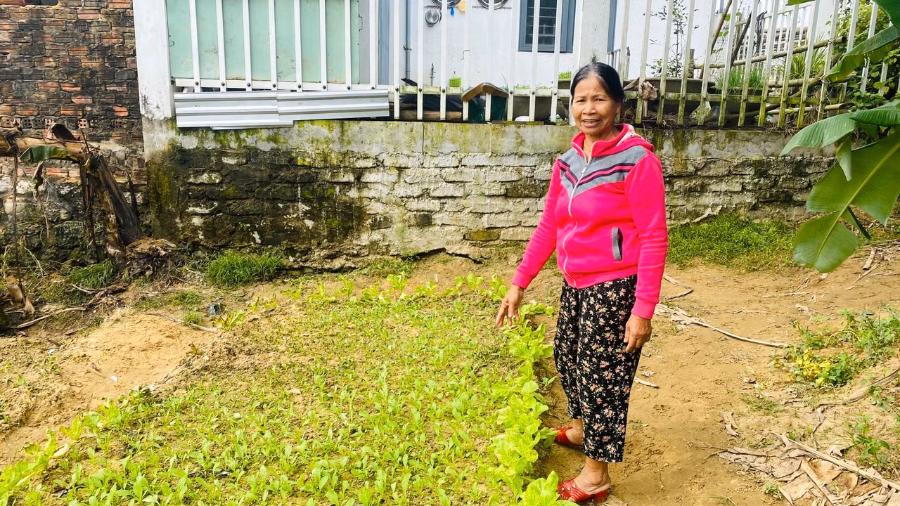 Bà Hứa Thị Dân (áo đỏ) nhận được 4 triệu đồng tiền bồi thường thiệt hại sau sự cố máy bay rơi.