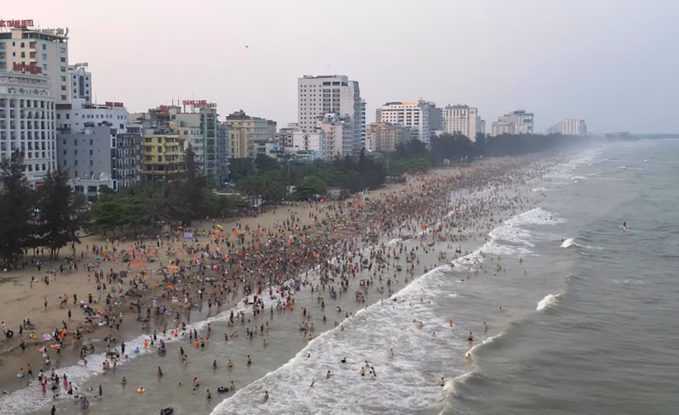 Giữa cái nắng nóng đầu hè, hàng vạn du khách và người dân địa phương đổ về Sầm Sơn tắm mát khiến bờ biển đông nghịt.