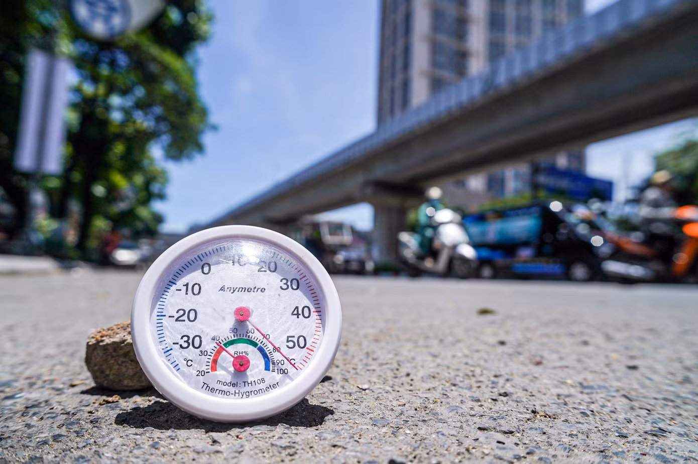 Lúc 12h, nhiệt độ ngoài trời tại Hà Nội là 37 độ C, nhưng nhiệt độ đo thực tế trên mặt đường vượt mức 50 độ C, cường độ ánh sáng rất mạnh.