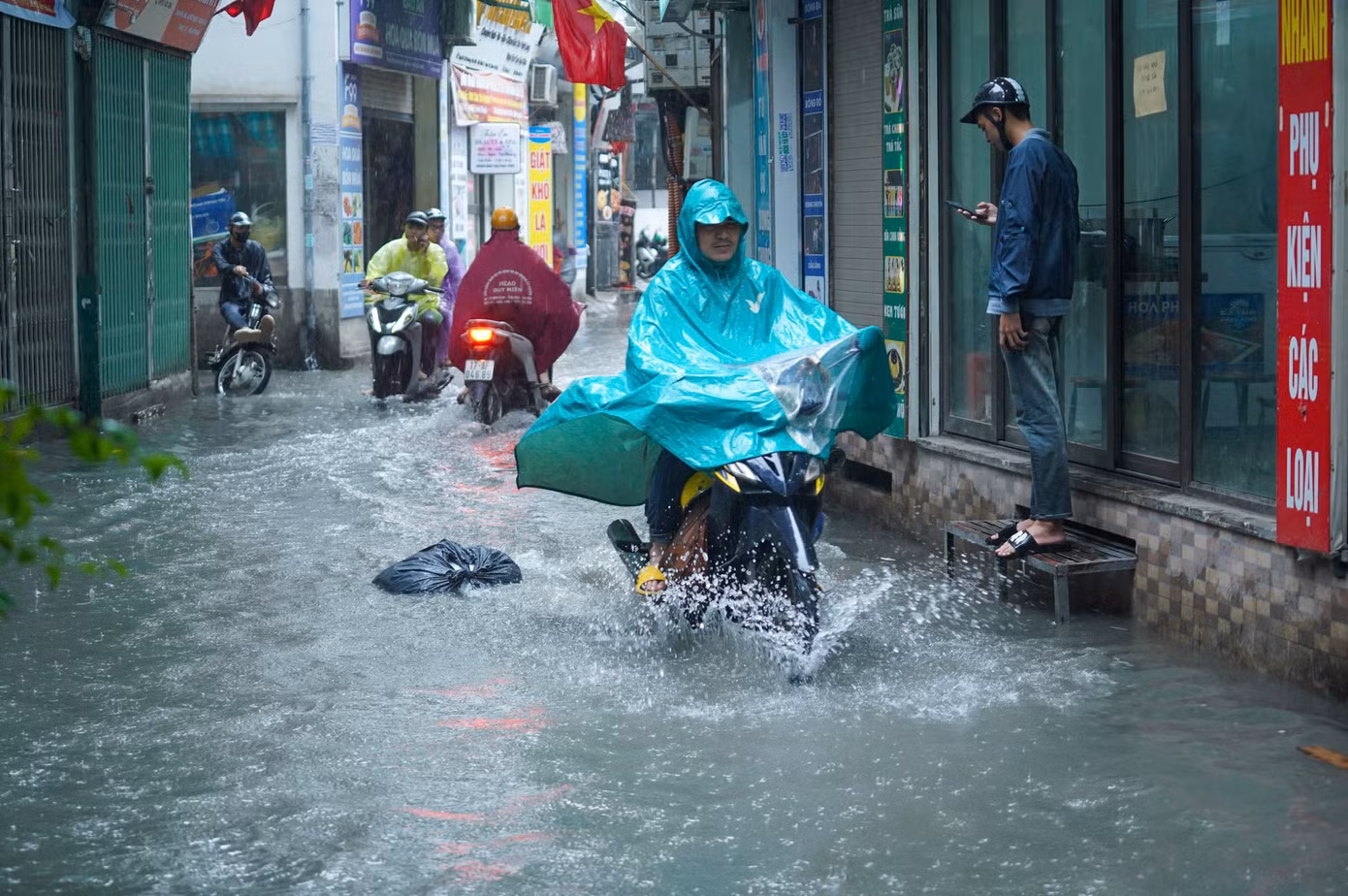 Mực nước dâng cao chừng 25cm gây khó khăn và nguy hiểm cho người tham gia giao thông.