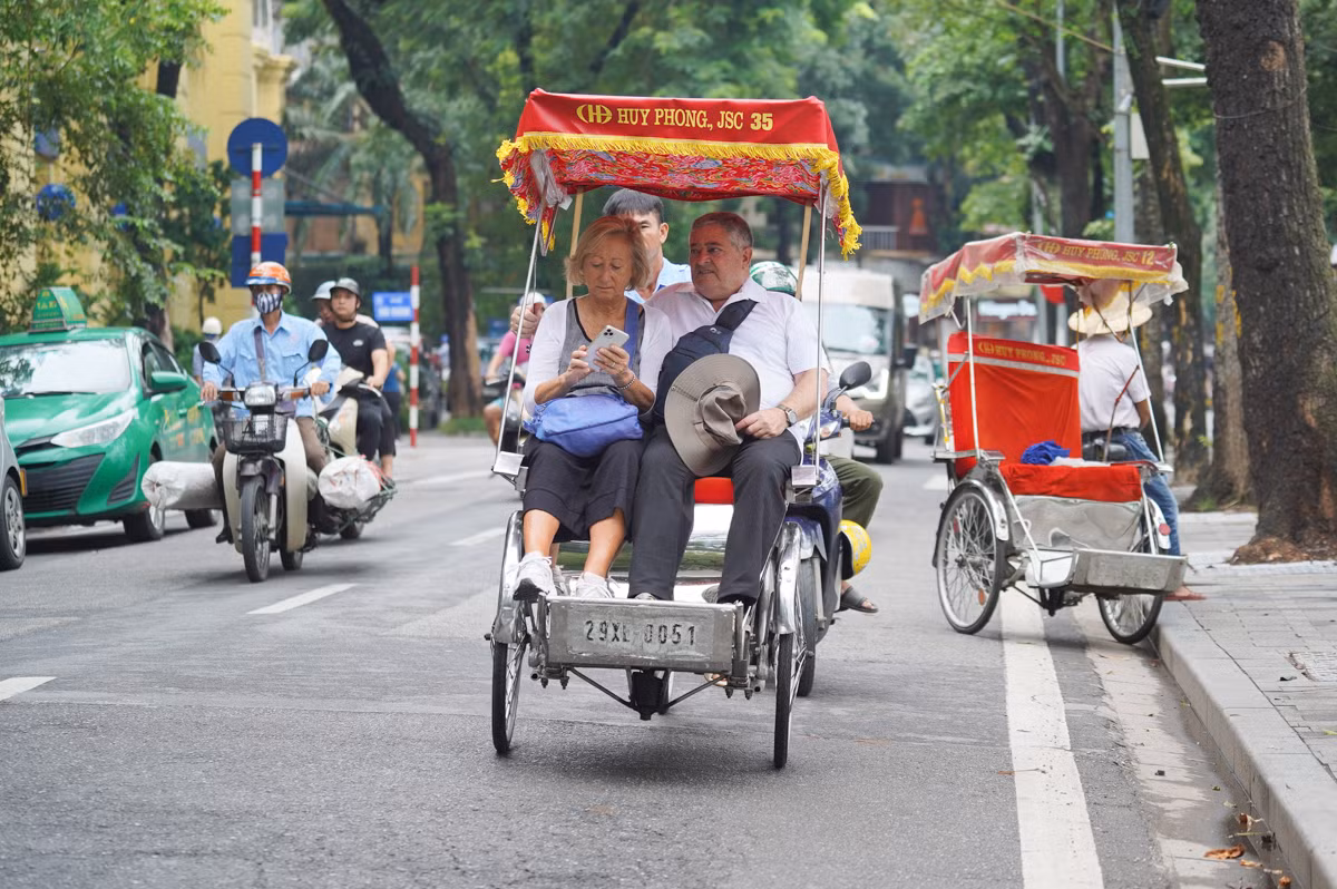 Người dân đạp xe, khách ngồi xích lô dạo phố, tận hưởng không khí mát mẻ của Thủ đô.