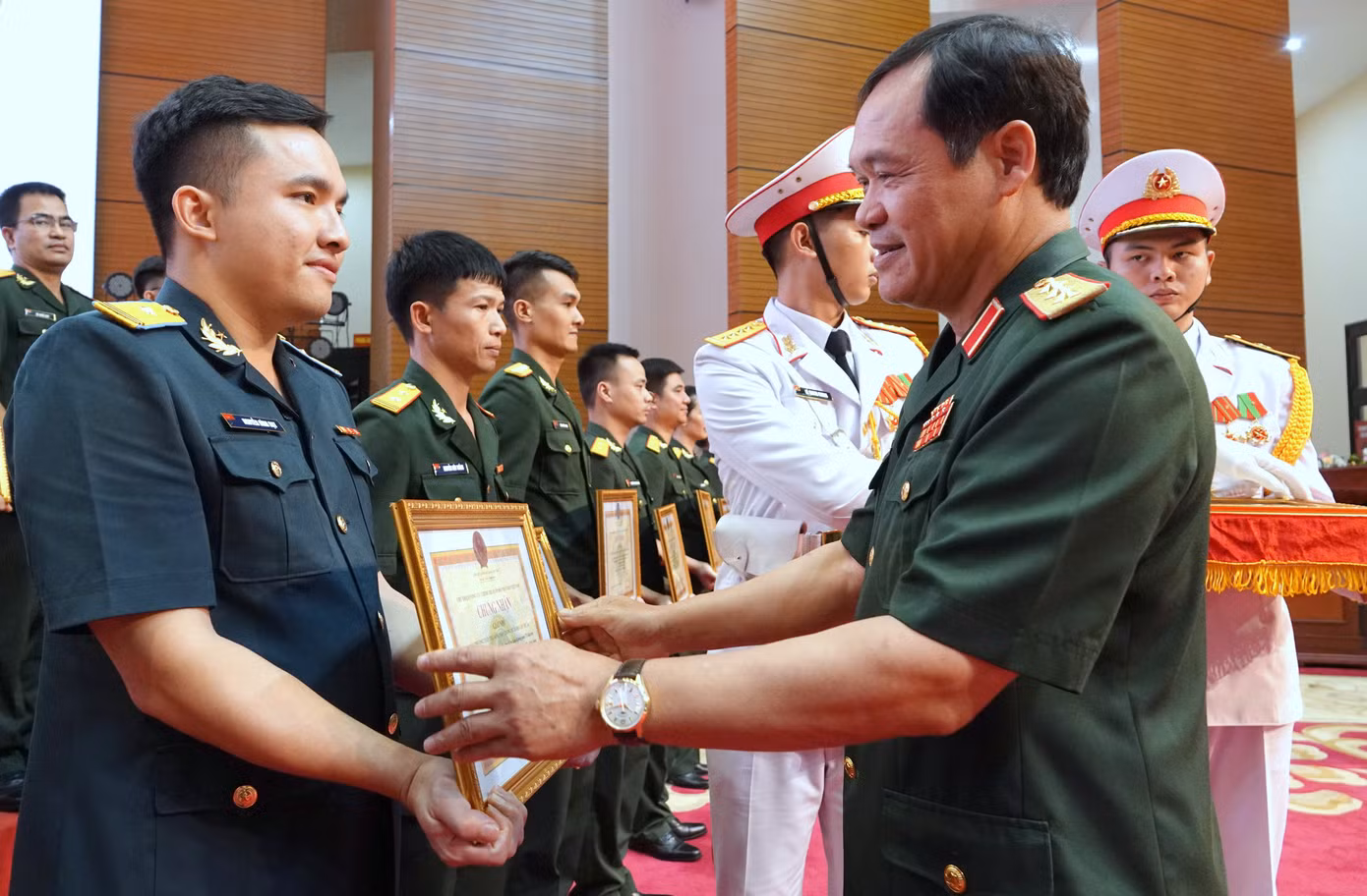 Thứ trưởng Bộ Quốc phòng Vũ Hải Sản và Phó Trưởng ban Tuyên giáo Trung ương Vũ Thanh Mai trao thưởng các tác giả đoạt giải nhì.