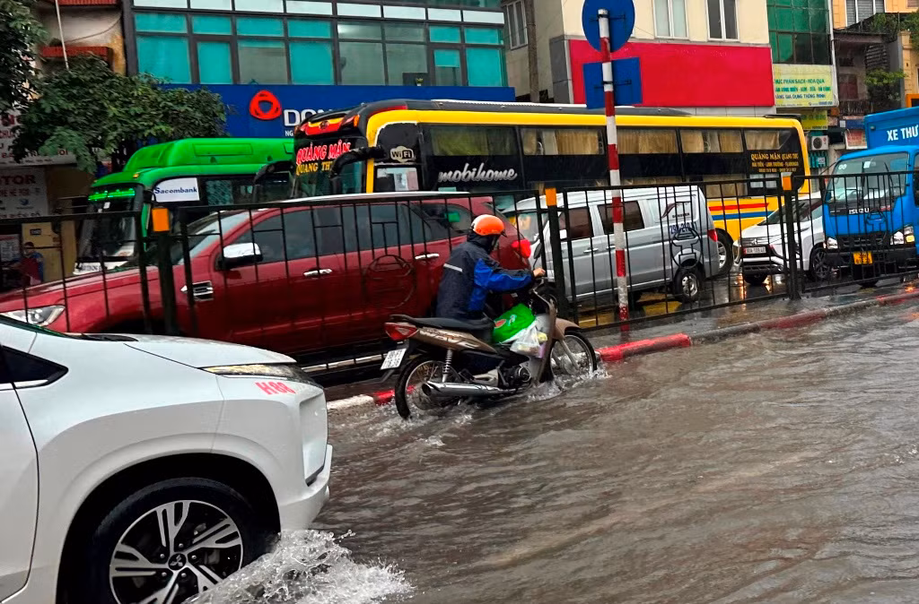 Trên đường Giải Phóng hướng đi Ngọc Hồi, nhiều xe chết máy do ngập nước. Người đi đường phải dắt xe qua điểm ngập úng.