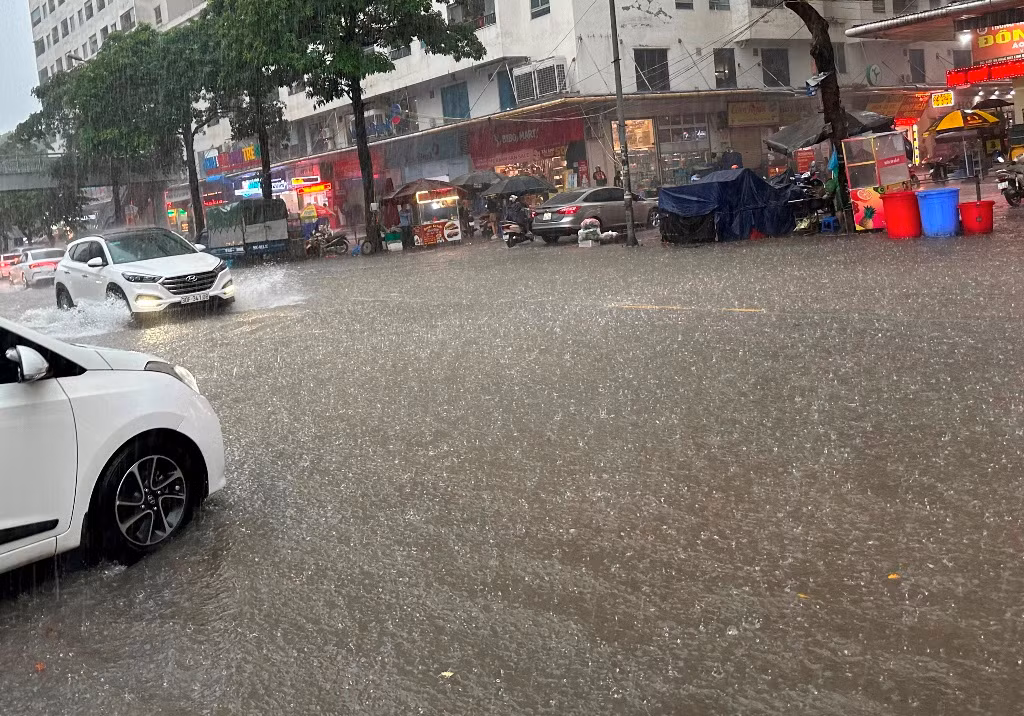Trên các phố Nguyễn Hữu Thọ, Giải Phóng, Linh Đường, Định Công... nước ngập sâu. Nhiều xe máy, ô tô gầm thấp không dám đi qua.