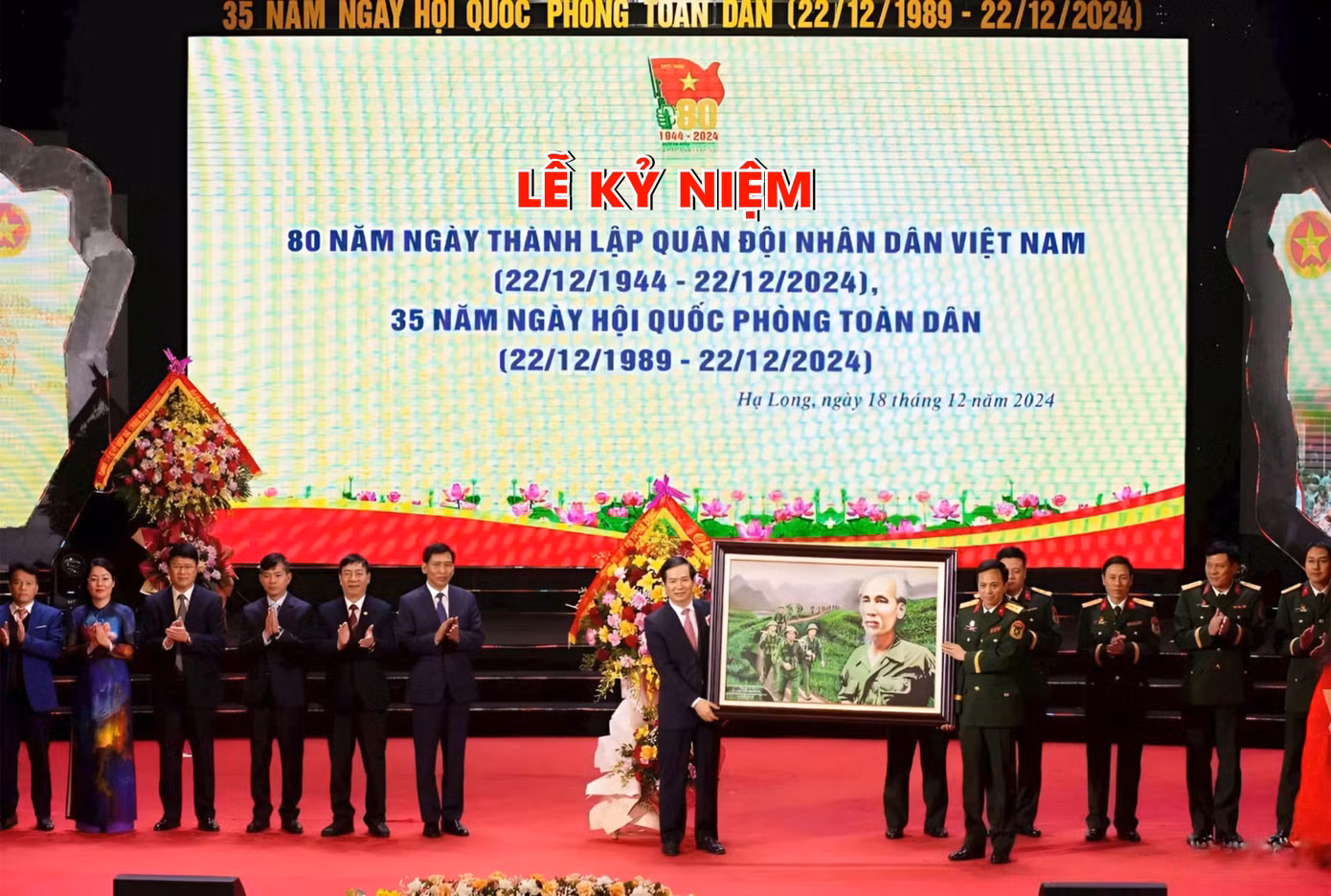 Lãnh đạo thành phố Hạ Long tặng hoa và tranh lưu niệm Bác Hồ cho đại diện lực lượng vũ trang thành phố.