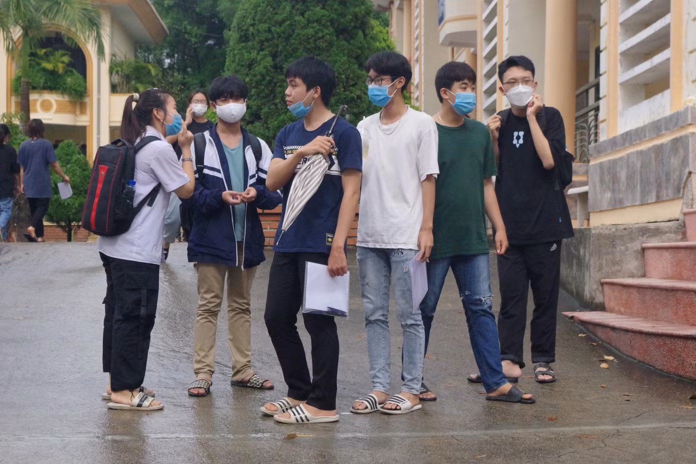 Các sĩ tử nán lại điểm thi để trao đổi về đề tiếng Anh.