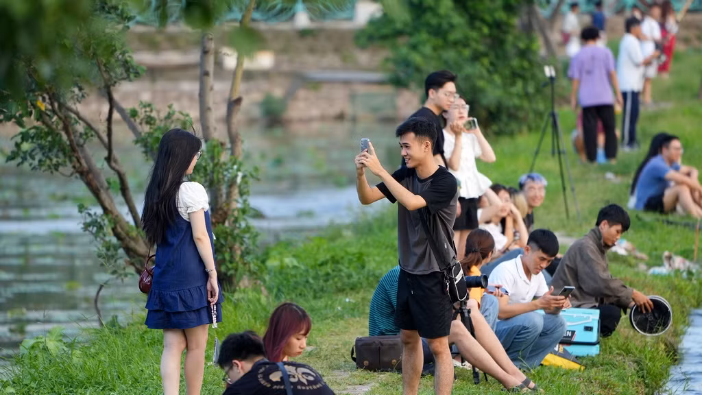 Đoạn đê giữa mặt nước Hồ Tây và những đầm sen luôn là địa điểm được nhiều bạn trẻ lựa chọn chụp hình vào những buổi chiều hè.