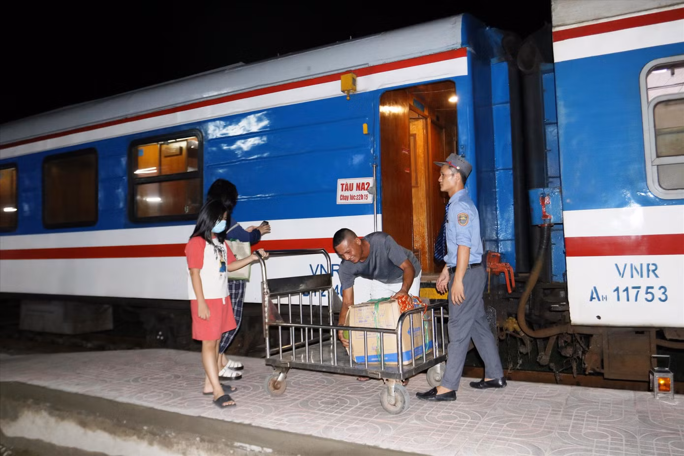 Cửu vạn ga Vinh bốc hàng lên toa tàu cho hành khách