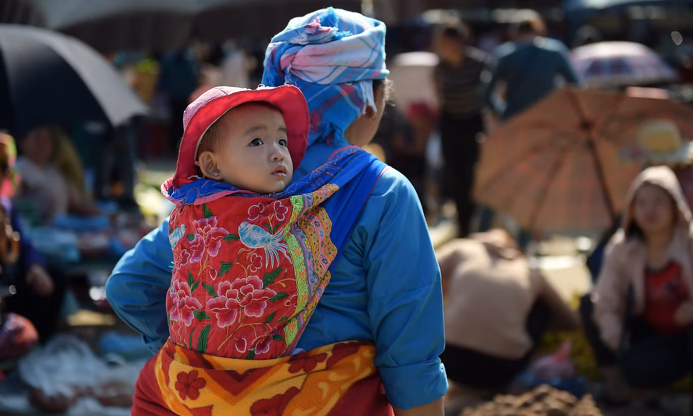 Chợ San Thàng như nhiều phiên chợ vùng cao khác không chỉ có cảnh bán mua, trao đổi hàng hóa, còn có những cảnh yên bình của các bé con theo chân người nhà đến chợ.