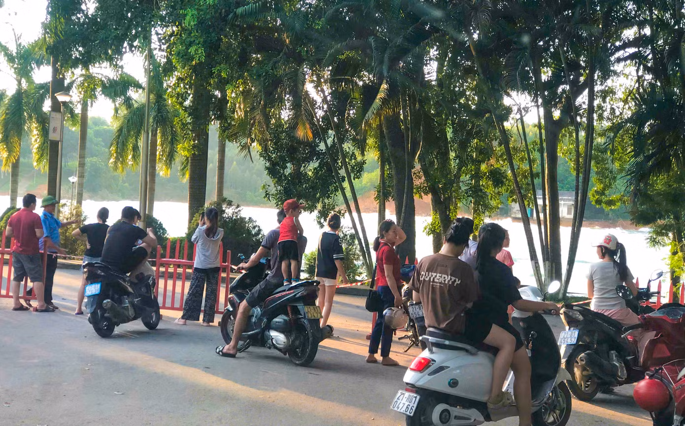 Thấy hồ thủy điện Thác Bà xả lũ, rất đông người dân địa phương và du khách di chuyển lên khu vực cửa xả để xem song bị bảo vệ ngăn lại để đảm bảo an toàn.