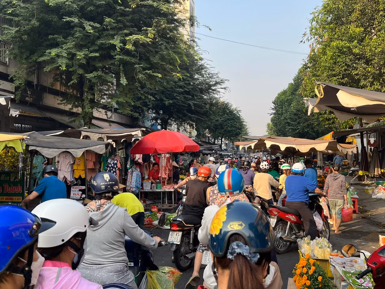 Dù đã trưa, đường vào chợ vẫn đông nghịt khách