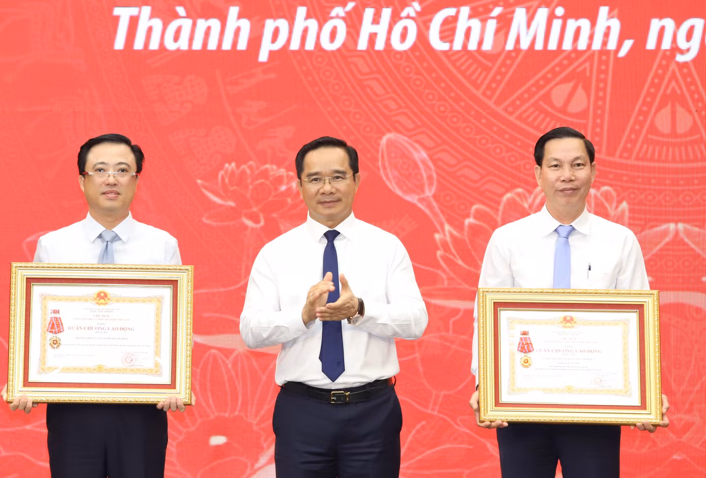 Chủ tịch UBND TPHCM trao Huân chương Lao động của Chủ tịch nước cho đại diện Ủy ban MTTQ Việt Nam quận 7 và Sở Công Thương TPHCM. Ảnh: Ngô Tùng.