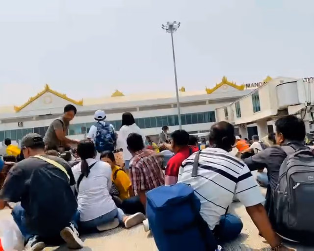 Hành khách tìm nơi ẩn náu tại sân bay Mandalay của Myanmar khi động đất xảy ra. Ảnh: X.