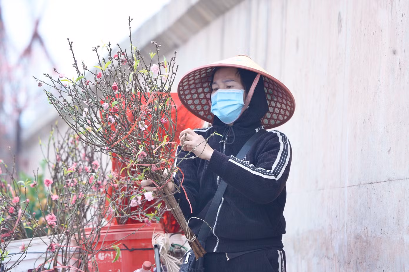 "Mọi năm nhiều người đi bán lắm nhưng năm nay vườn không đào mấy. Tôi đi khắp các vườn mới mua được vài cành để bán, mọi năm buổi sáng ngày rằm là tôi bán được 50 cành.", một tiểu thương bán cành đào tại chợ Quảng Bá chia sẻ.
