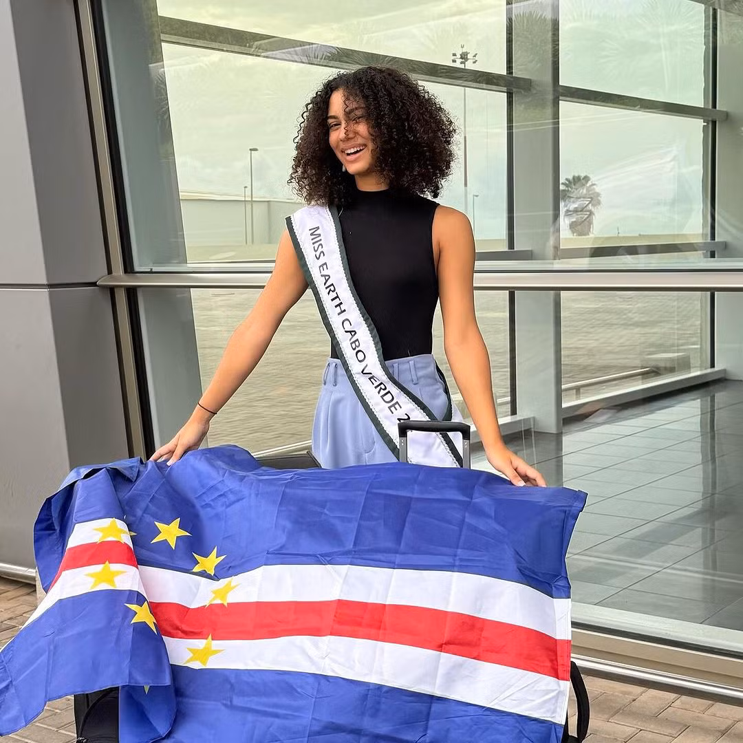 Đại diện Cabo Verde - Jasmine Jorgensen - để mặt mộc ra sân bay. Cô năm nay 19 tuổi, là sinh viên chuyên ngành kinh doanh. Thông qua công việc của mình, Jasmine hướng đến mục tiêu đề cao môi trường tự nhiên trong các chiến lược cho sức khỏe tinh thần và thúc đẩy các hoạt động bền vững.