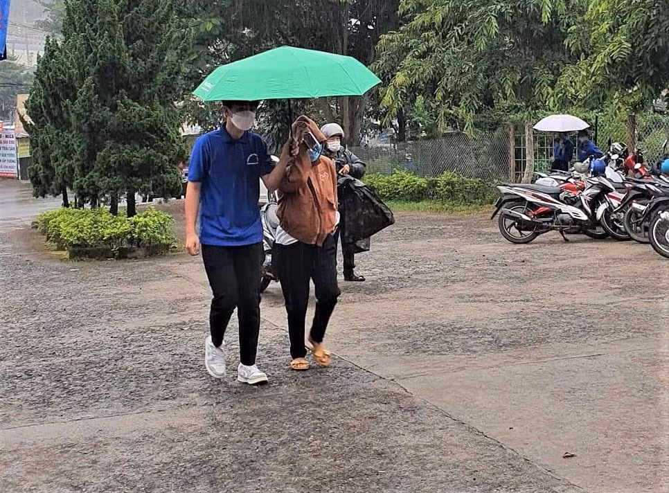 Tình nguyện viên che mưa cho thí sinh