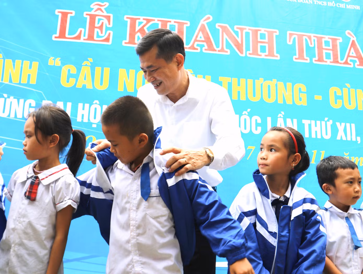 GS.TS Thái Văn Thành trao áo khoác tặng các em học sinh tại lễ khánh thành.