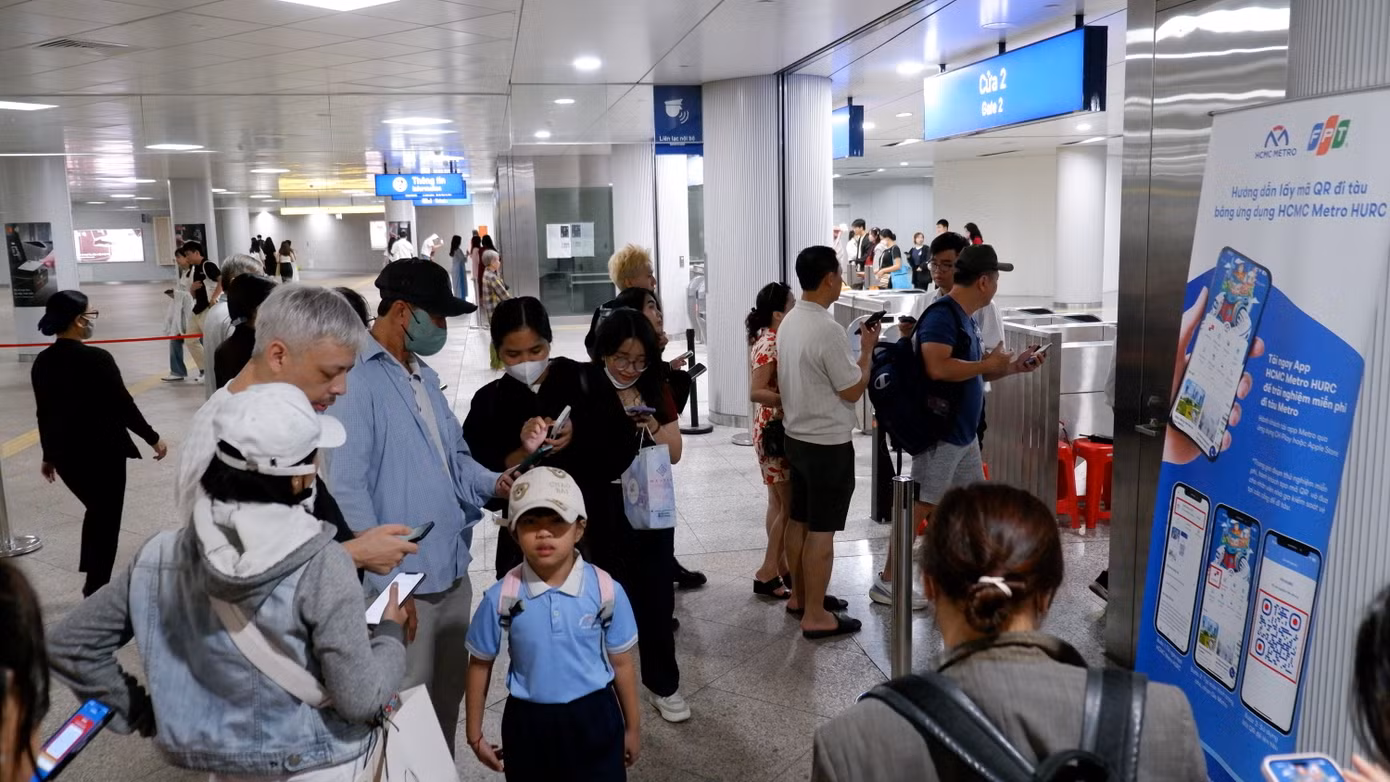 Hành khách tải ứng dụng HCM METRO để đi tàu tại nhà ga Bến Thành, quận 1.