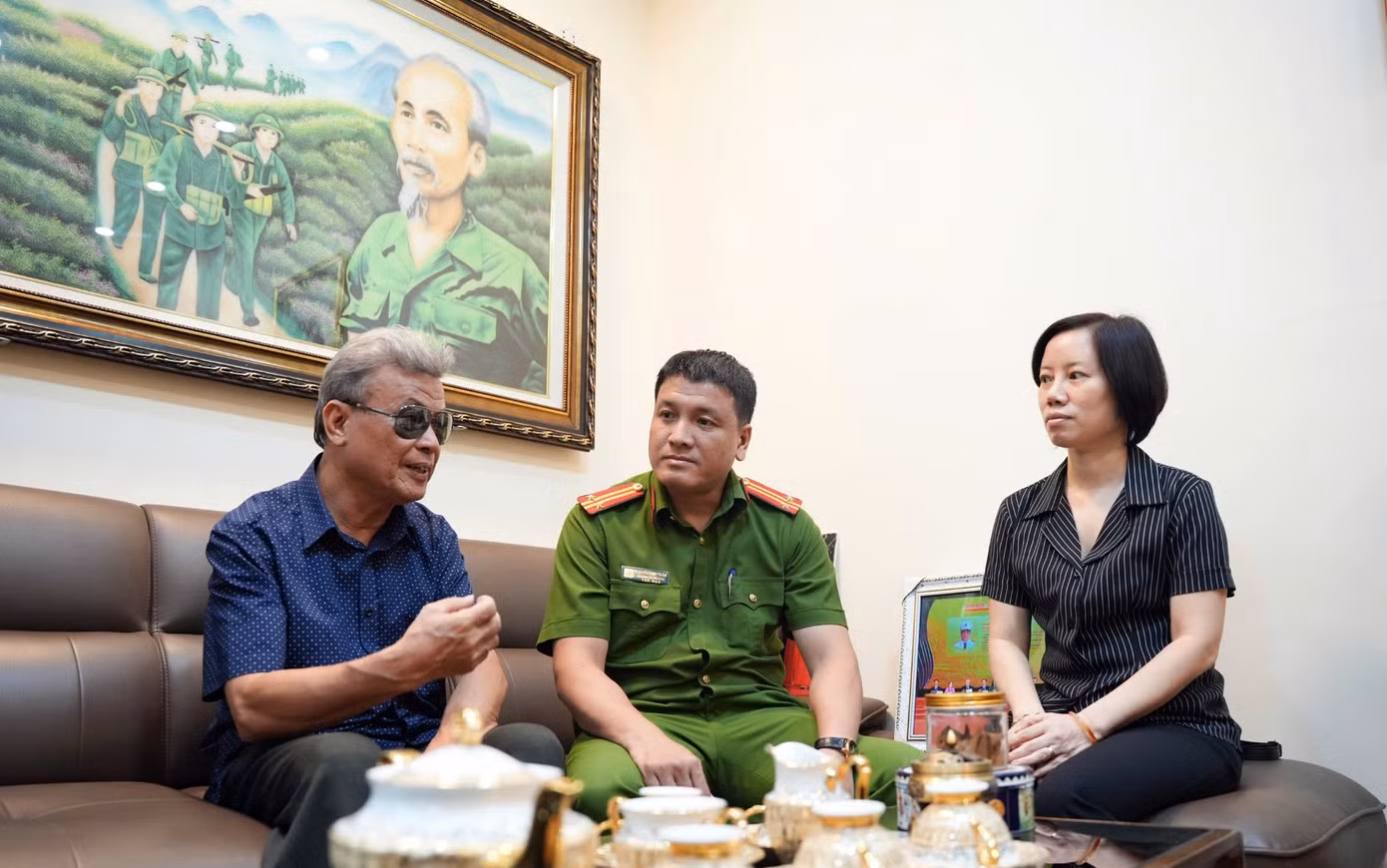 Ông Bạch Đăng Quảng - Tổ trưởng Tổ dân phố 28 phường Láng Hạ trao đổi với trung tá Nguyễn Anh Tuấn về vấn đề an ninh trật tự, cấp thẻ căn cước trên địa bàn. Ảnh: Công Hướng.