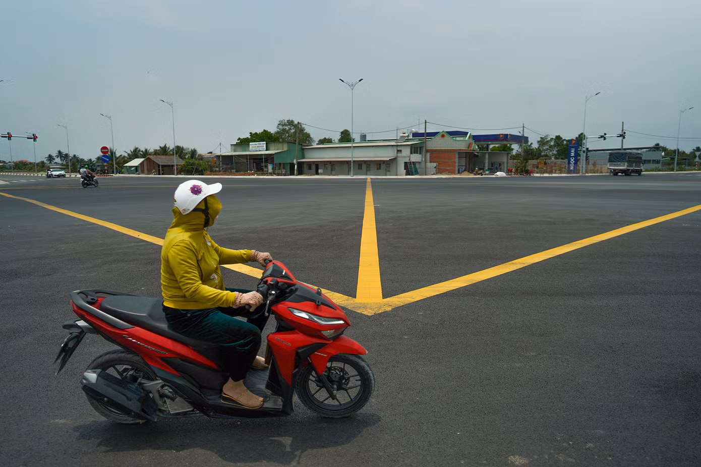 "Giờ vòng xoay này được mở rộng, trải nhựa phẳng lì, chạy xe cảm giác nó lạ lắm", chị Lê Thị Uyên chia sẻ trong lúc dừng đèn đỏ.