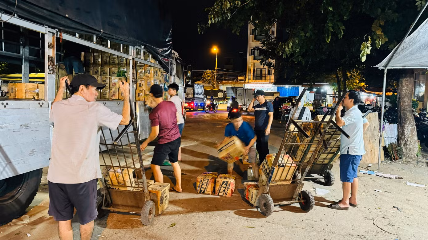 Khi những chiếc xe hàng vừa đáp bến ở bên trong khu vực chợ cũng là lúc những người làm nghề “cửu vạn” bắt tay vào công việc mưu sinh. Ảnh: Nguyễn Ngọc