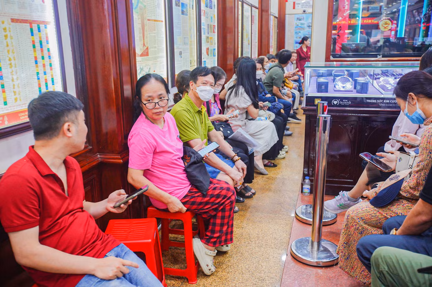 Phía bên trong cửa hàng, người đứng người ngồi chật kín lối đi.