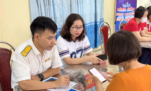 Cán bộ thuế hướng dẫn thủ tục cho người nộp thuế. Ảnh: Thuế Hà Nội